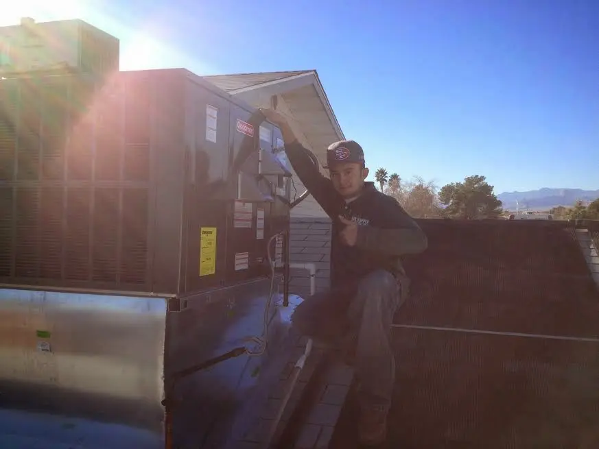 HVAC technician performing AC Tune-Up on a rooftop unit in Morris Plains